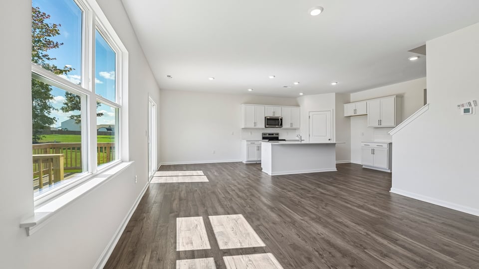 open concept living area overlooked by kitchen
