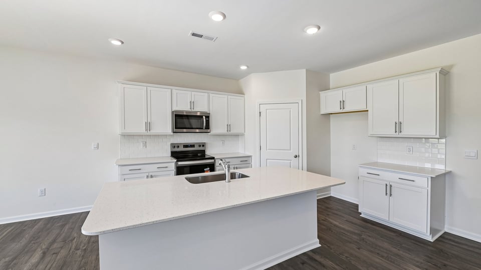 kitchen with white cabinets quartz countertops and center island