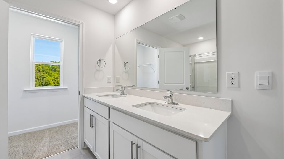 bathroom with dual vanity white cabinets and quartz countertops