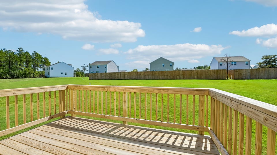 uncovered back deck with spacious backyard