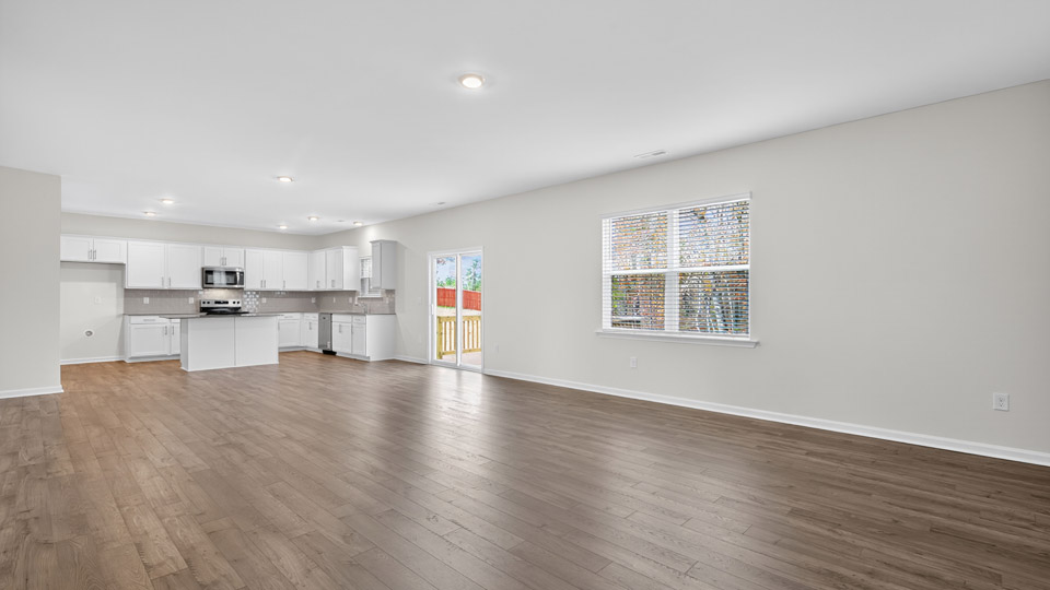 kitchen with quartz counters, kitchen island, pantry, stainless steel appliances