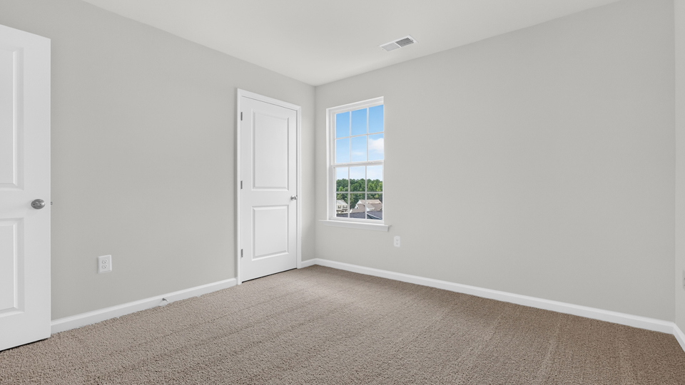 additional bedroom with window, carpeting, closet