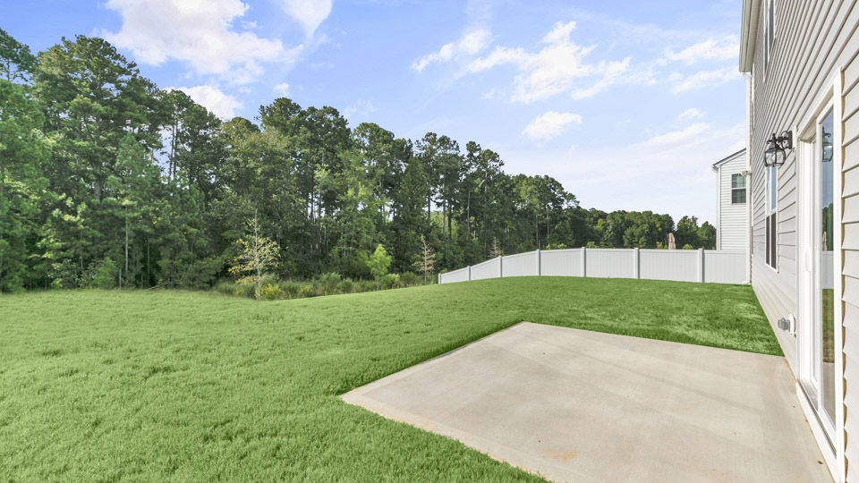 exterior patio with concrete slab and open yard
