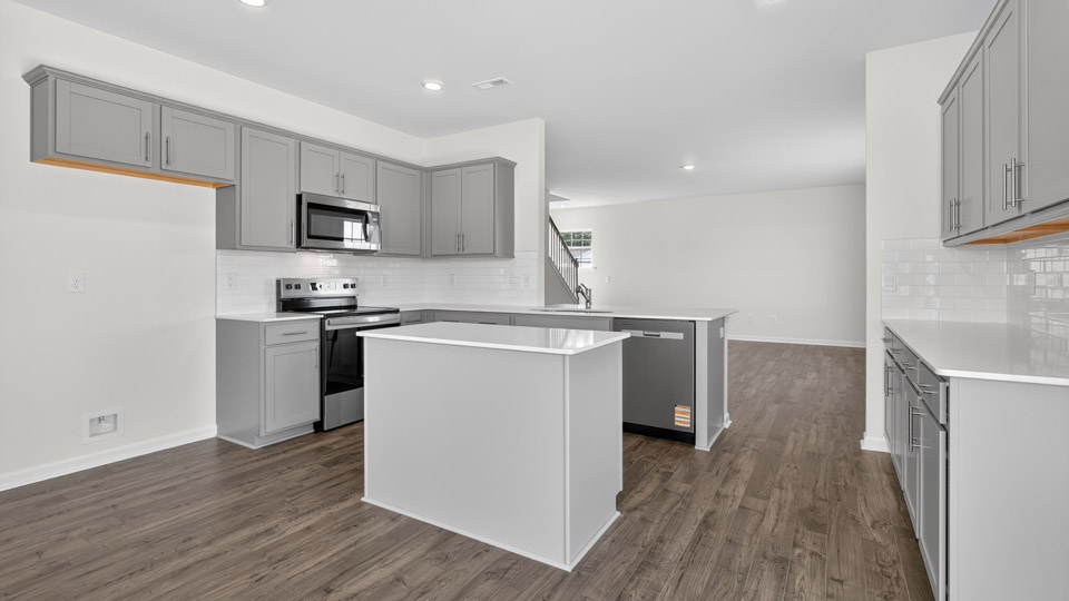 Kitchen with gray cabinets and stainless steel appliances.