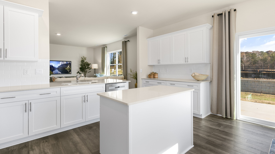 kitchen with white cabinets white quartz countertops and island