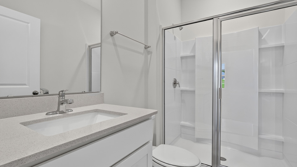 secondary bathroom with shower tub combo and dual vanity sink