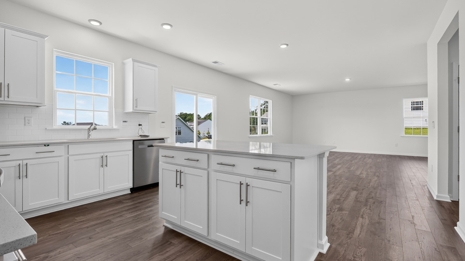 kitchen with quartz counters, kitchen island, pantry, stainless steel appliances