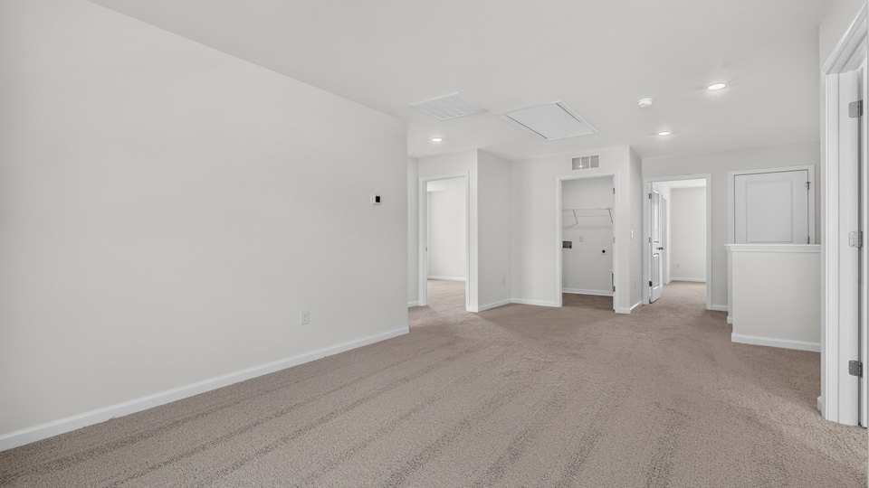 upstairs loft area with large windows and carpeting