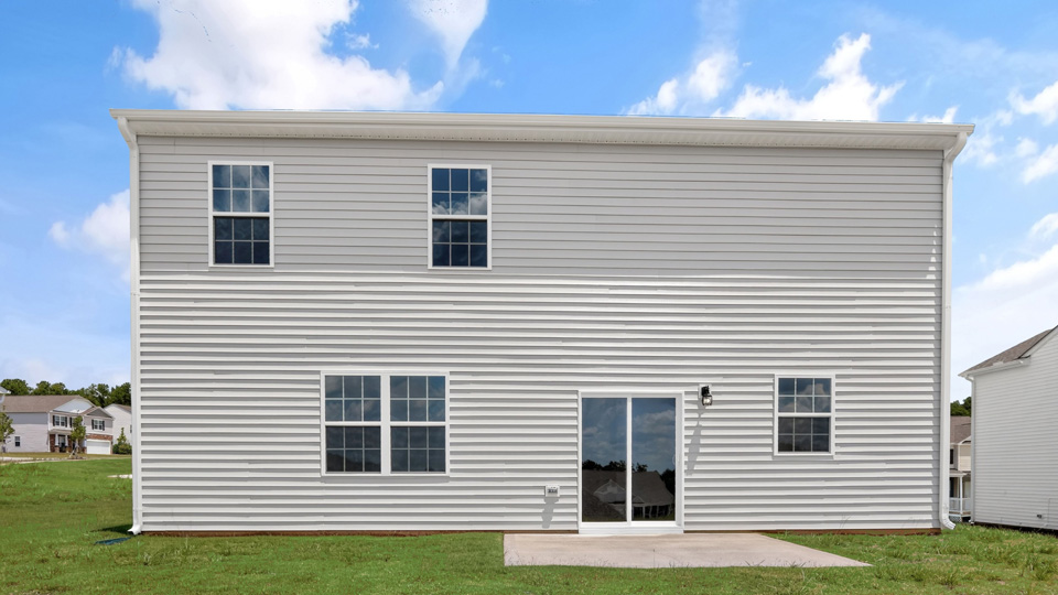 baxk exterior of Hanover with open yard and patio