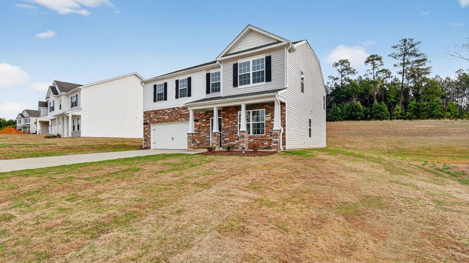 Two story home with white colored siding with a two car garage