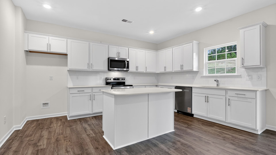 Kitchen with white cabinets and stainless steel appliances.