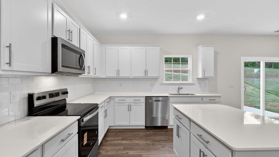 Kitchen with white cabinets and stainless steel appliances.
