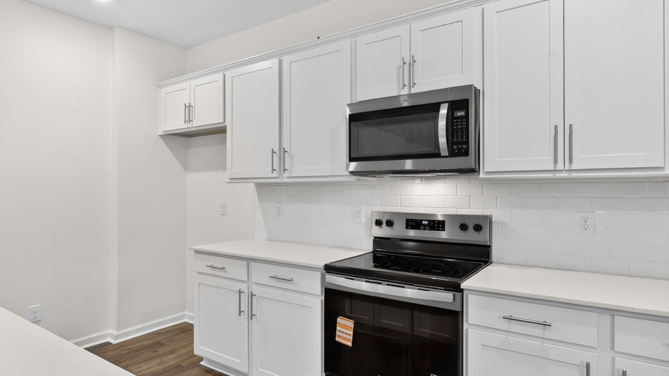 Kitchen with white cabinets and stainless steel appliances.