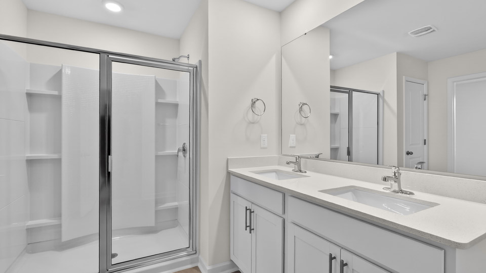 Primary bathroom with double sink and walk-in shower