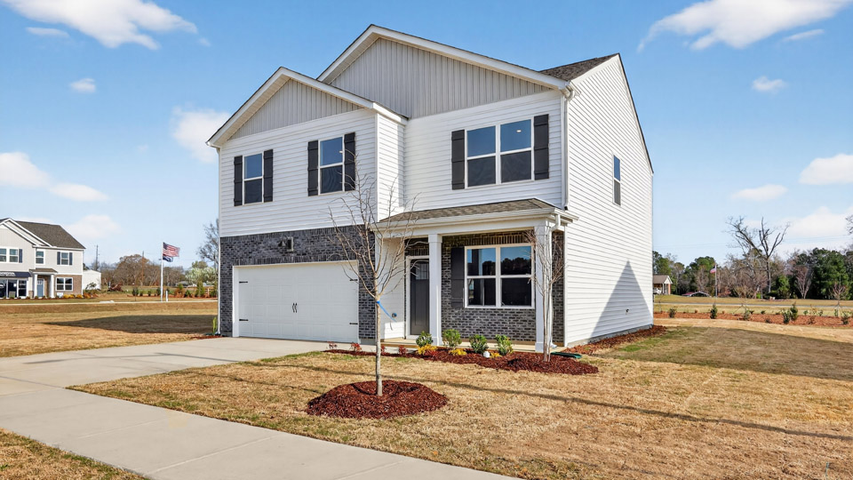 Two story home with white colored siding with a two car garage