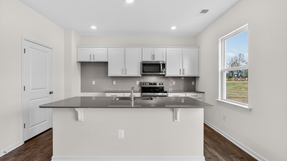 Kitchen with white cabinets and stainless steel appliances.