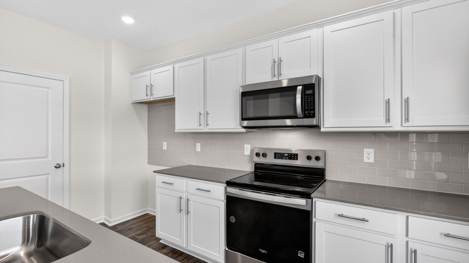Kitchen with white cabinets and stainless steel appliances.