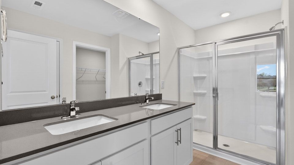 Primary bathroom with double sink and walk-in shower