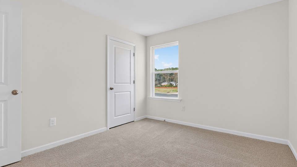 Third bedroom with carpet floor and closet