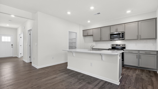 kitchen with gray cabinets island and quartz countertops