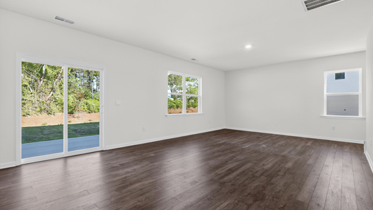 living and dining areas with sliidng glass doors to patio