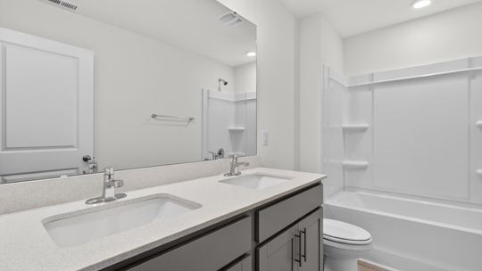 bathroom with tub shower combo and quartz countertops