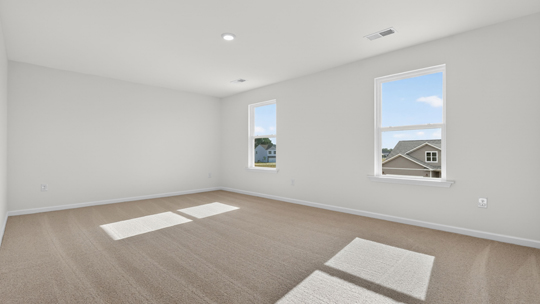 primary bedroom with carpet flooring