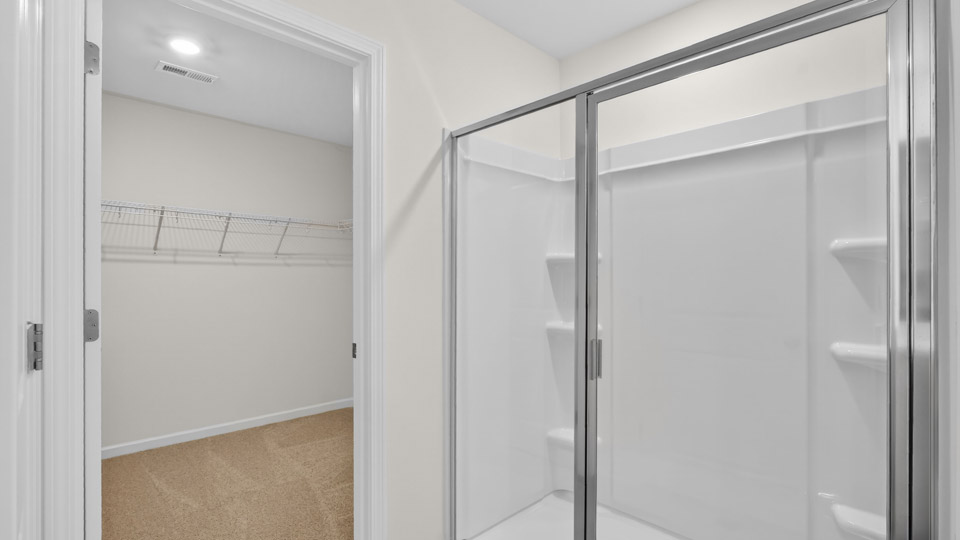 Primary bathroom with double sink and walk-in shower