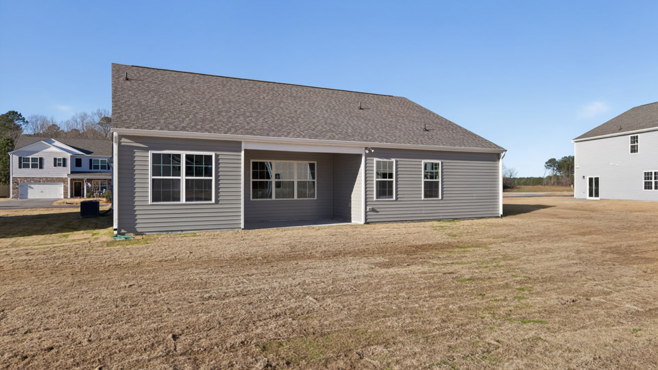 One story home with gray siding and a covered back patio