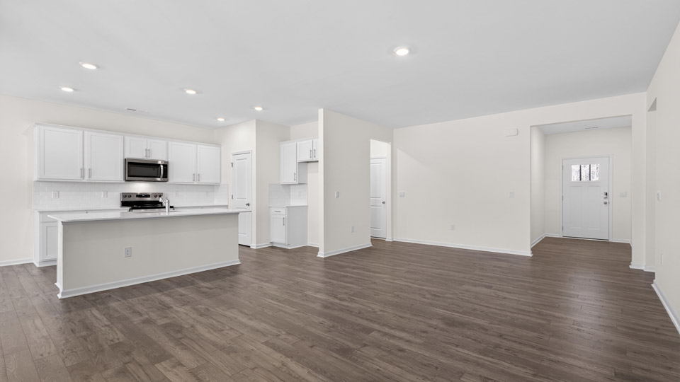 Open-concept living room leading to kitchen