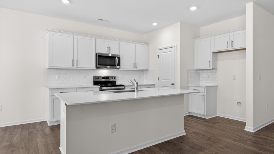 Kitchen with white cabinets and stainless steel appliances.