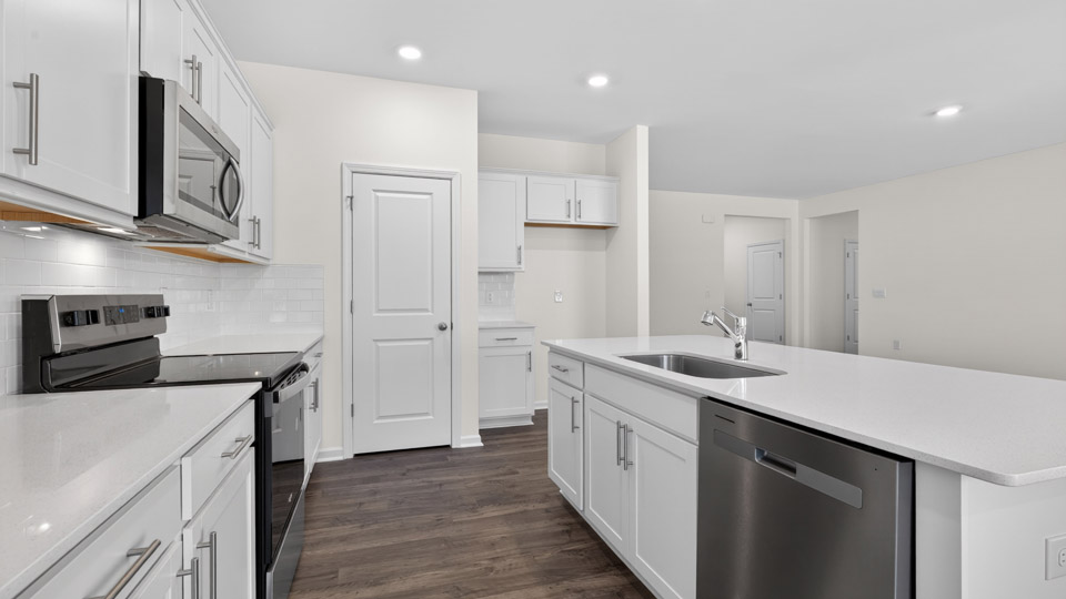 Kitchen with white cabinets and stainless steel appliances.