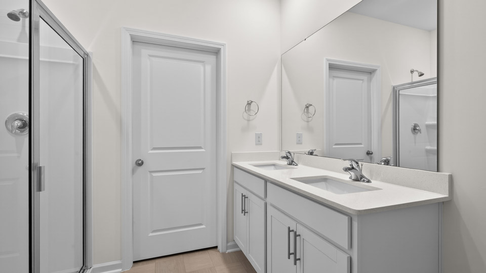 Primary bathroom with double sink and walk-in shower