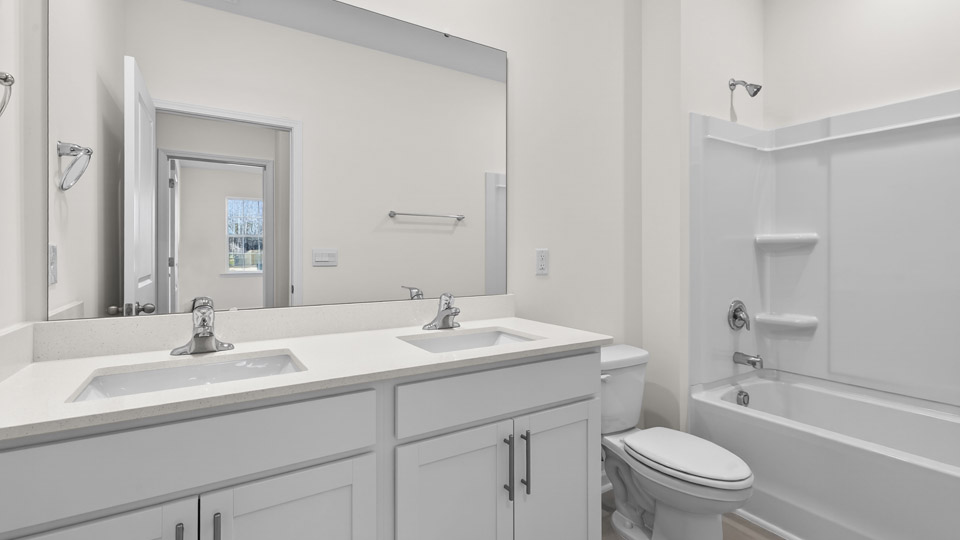 Bathroom with double sink and tub