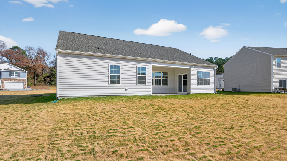 Single-story home with gray siding and a covered back patio