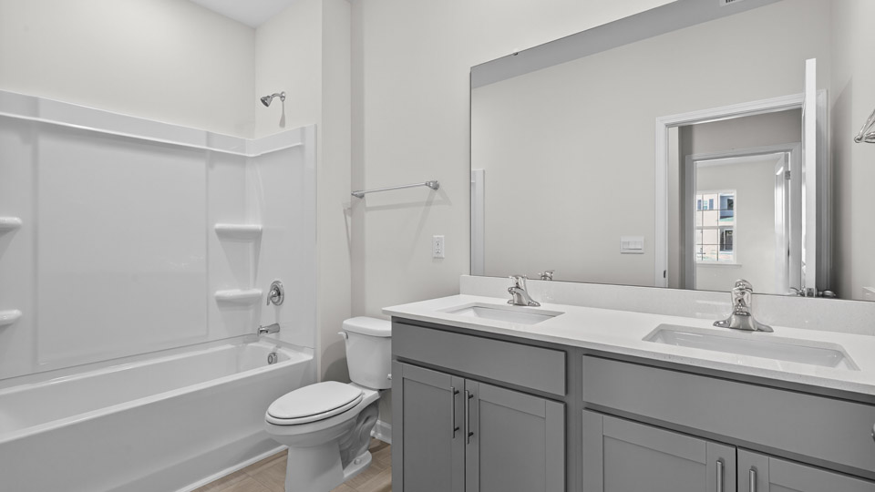 Bathroom with double sink and tub