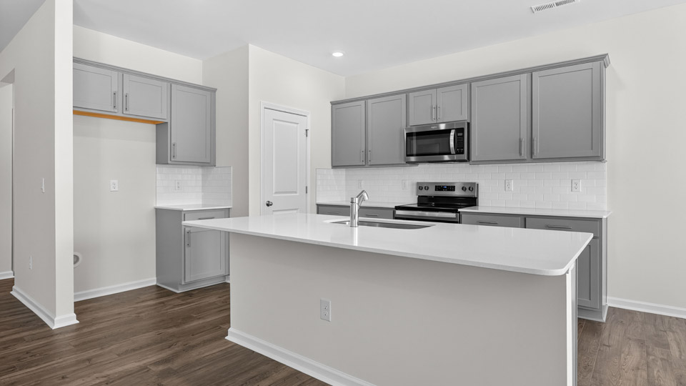 Kitchen with gray cabinets and stainless steel appliances.