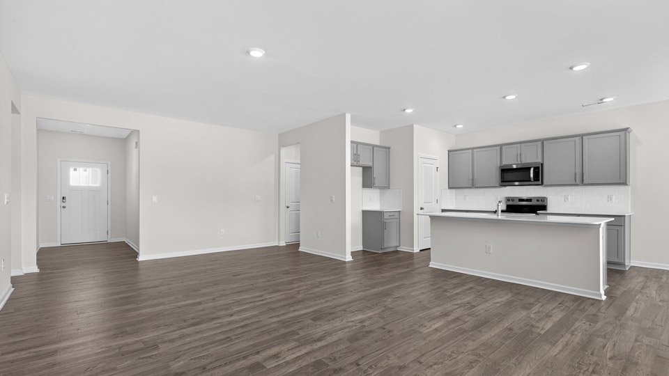 Open-concept living room leading to kitchen