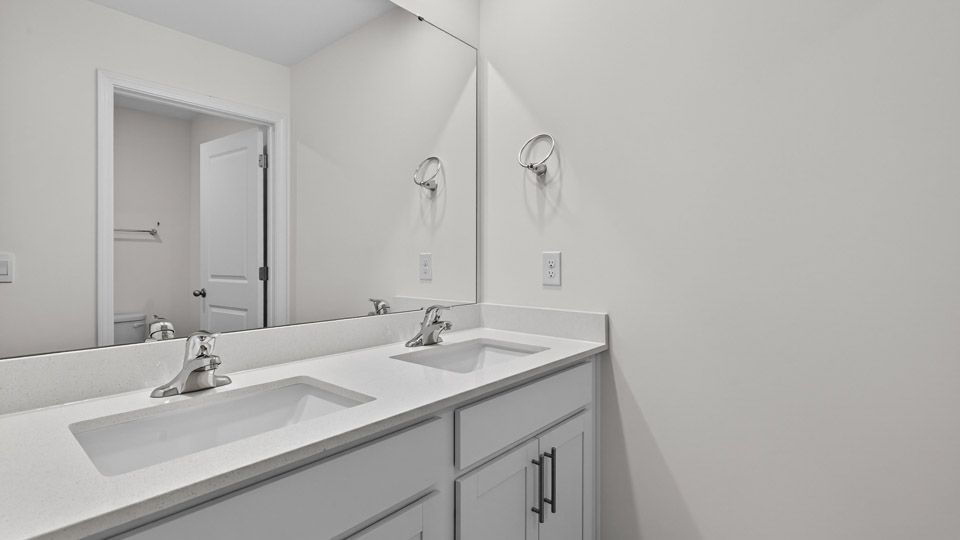 Bathroom with double sink and tub