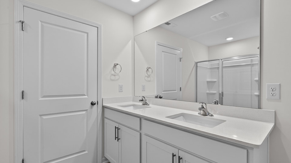Primary bathroom with double sink and walk-in shower