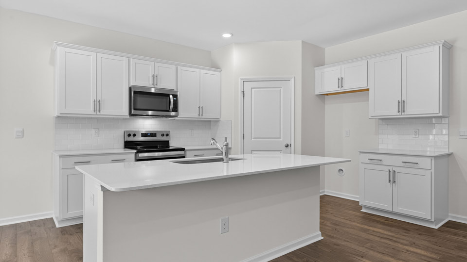 Kitchen with white cabinets and stainless steel appliances.