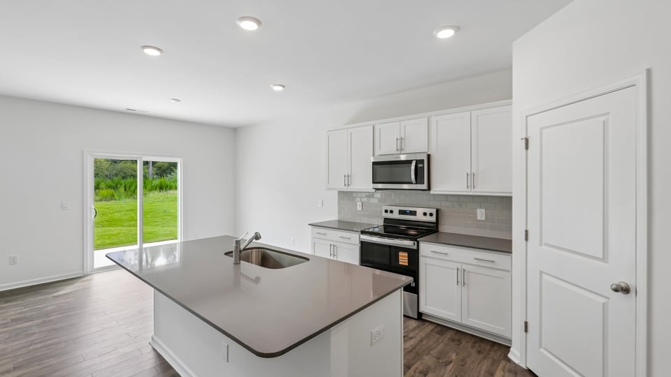 kitchen with island white cabinets and quartz countertops