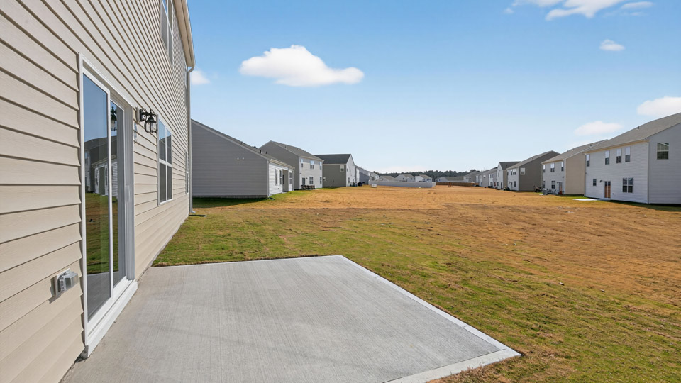 exterior patio with concrete slab and open yard