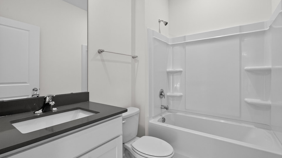 secondary bathroom with shower tub combo and single vanity sink