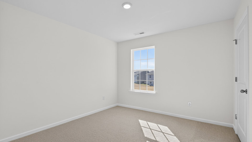 upstairs loft area with large windows and carpeting