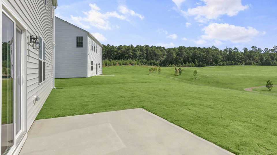 exterior patio with concrete slab and open yard