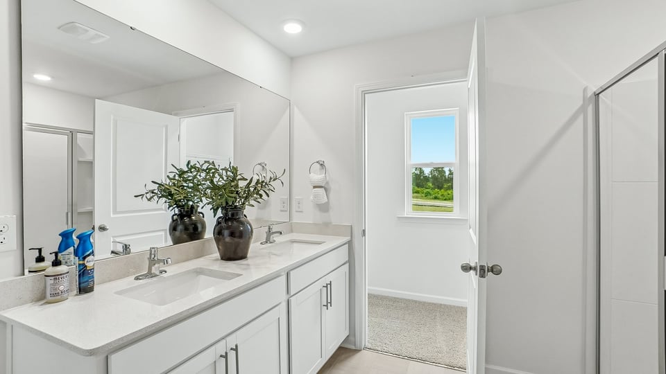 bathroom with walkin shower and walkin closet with window