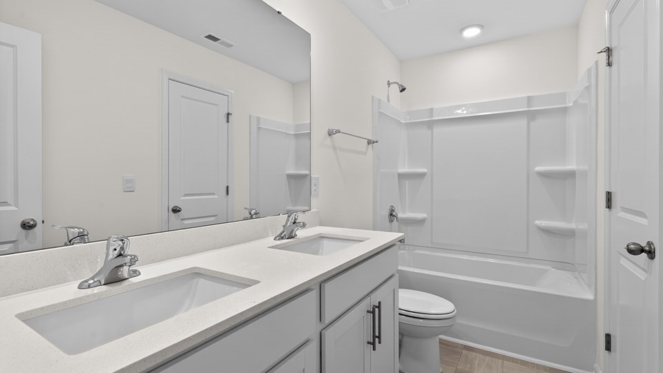 Bathroom with double sink and tub