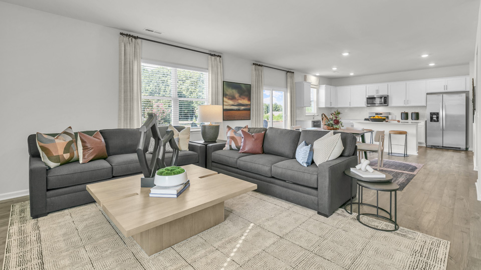 living room with plenty of natural lighting and revwood flooring