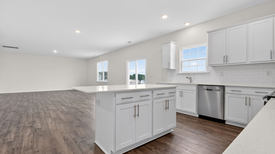 kitchen with quartz counters, kitchen island, pantry, stainless steel appliances